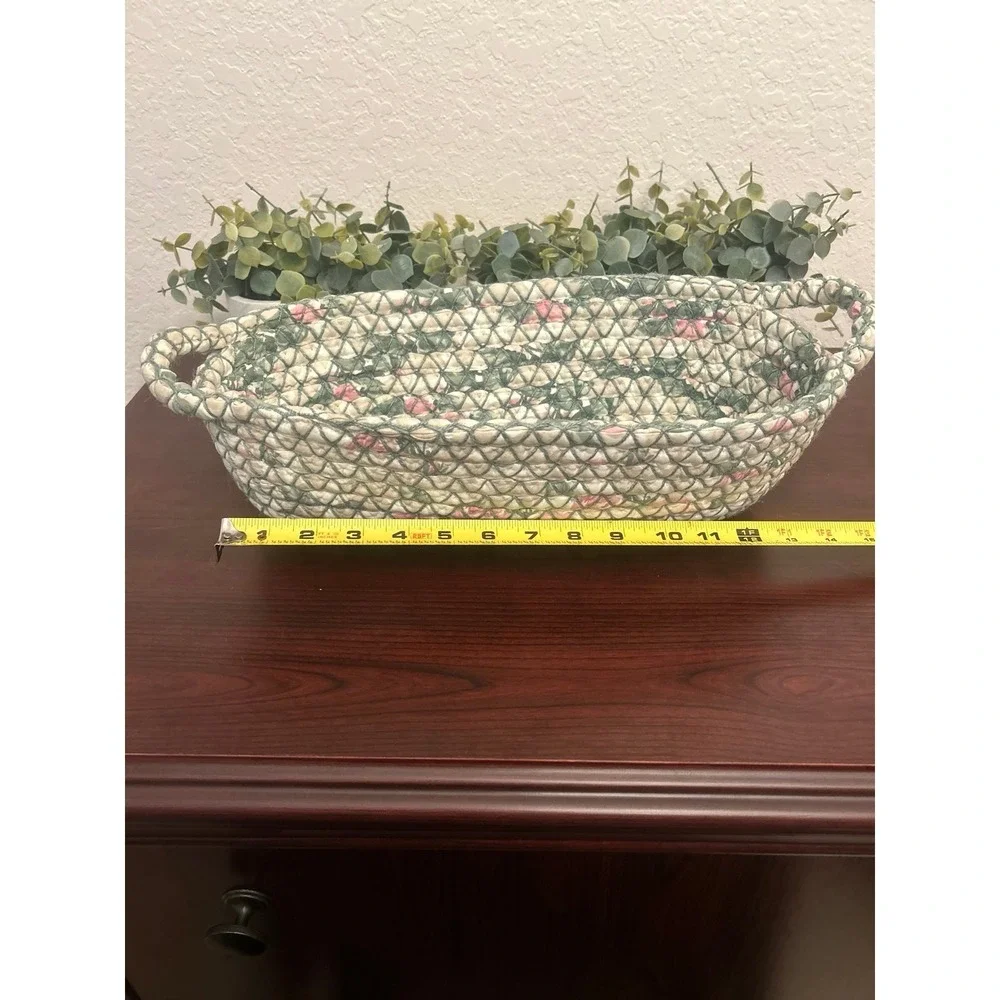 vintage oval rag rug basket features a braided, quilted design in green and pink
